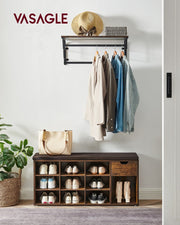 Shoe bench in a hallway under a coat rack, holding several pairs of shoes