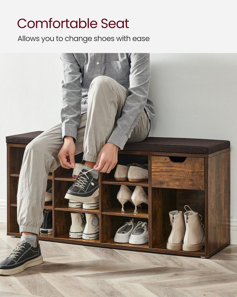 Person sitting on the cushioned bench top while tying their shoelaces