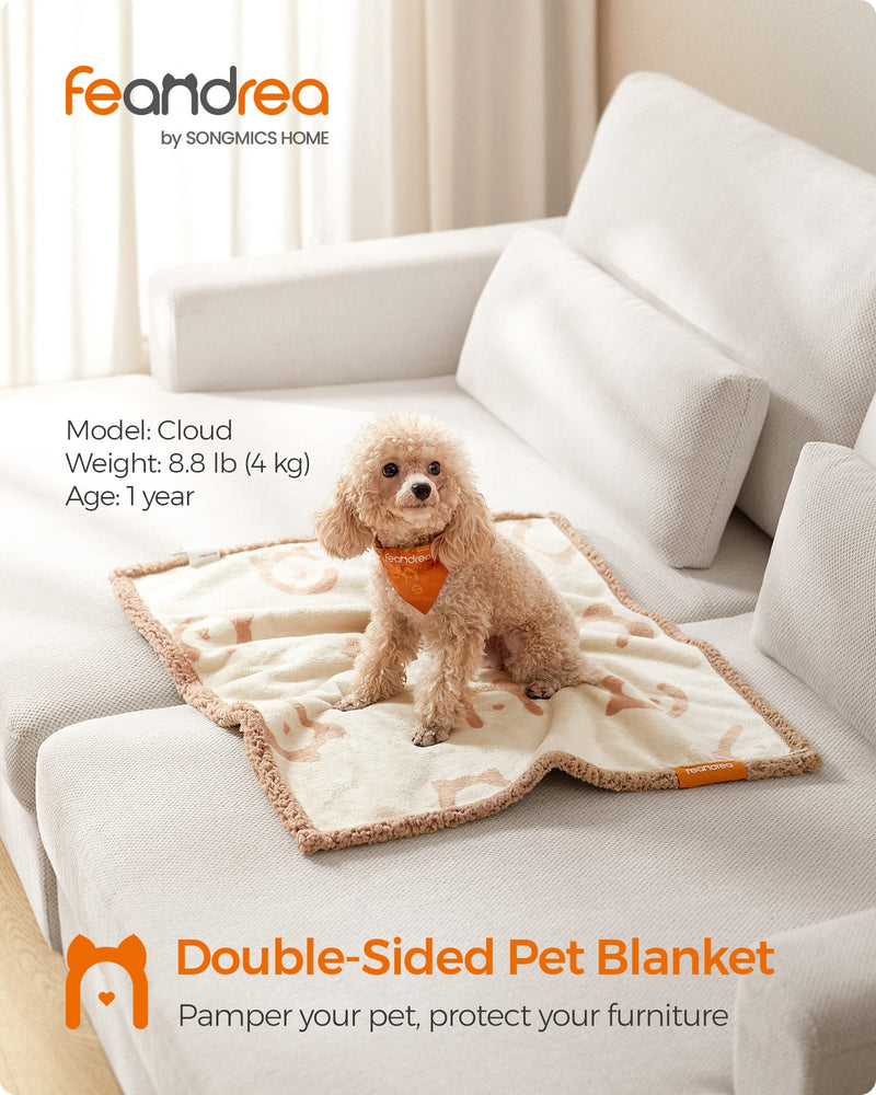 Lifestyle shot of the Feandrea double-sided pet blanket draped on a sofa with a small dog