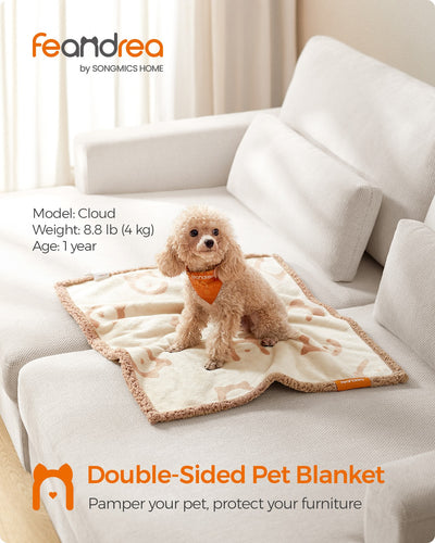 Lifestyle shot of the Feandrea double-sided pet blanket draped on a sofa with a small dog