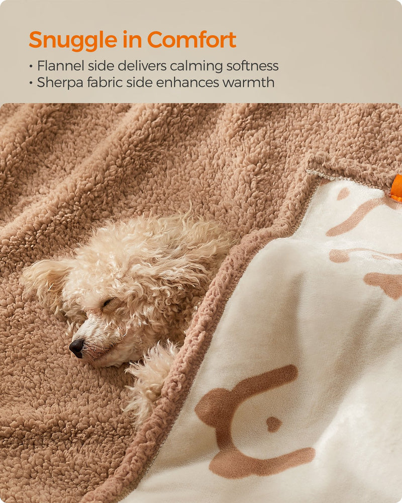 Close-up of a dog snuggled in the reversible sherpa and flannel sides of the blanket