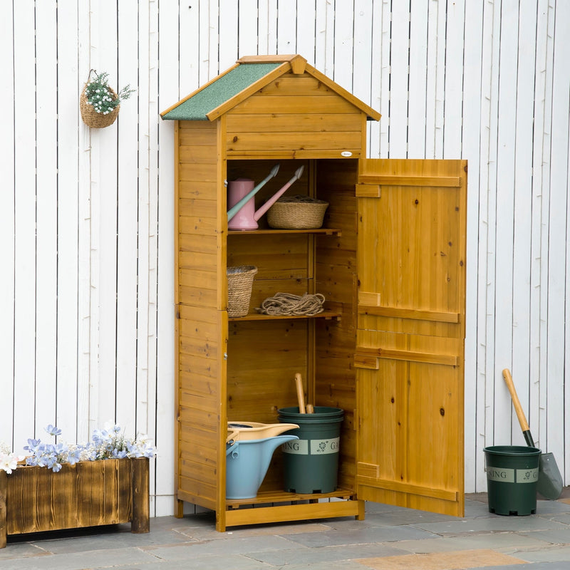 Wooden tool shed against a white fence with the door open showing shelves and plant pots