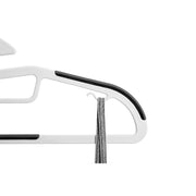 Close-up of the hanger shoulder with its grey non-slip strip and small side hook holding a strap