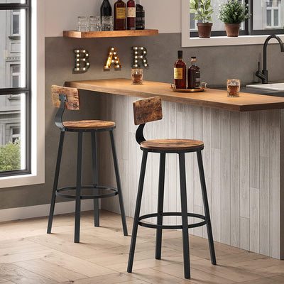 Two brown bar stools at a home bar counter with bottles and glasses
