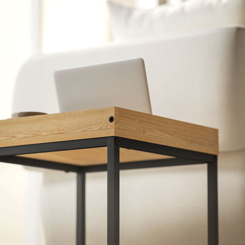 Close-up of the wood-effect tray tabletop corner with a laptop resting on top