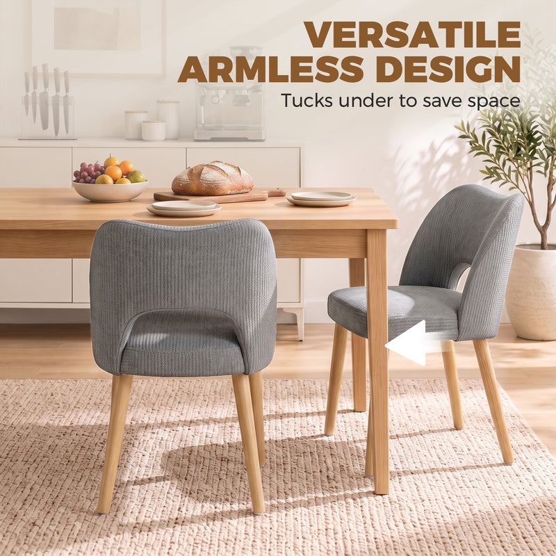 Armless grey dining chairs tucked under a wooden table