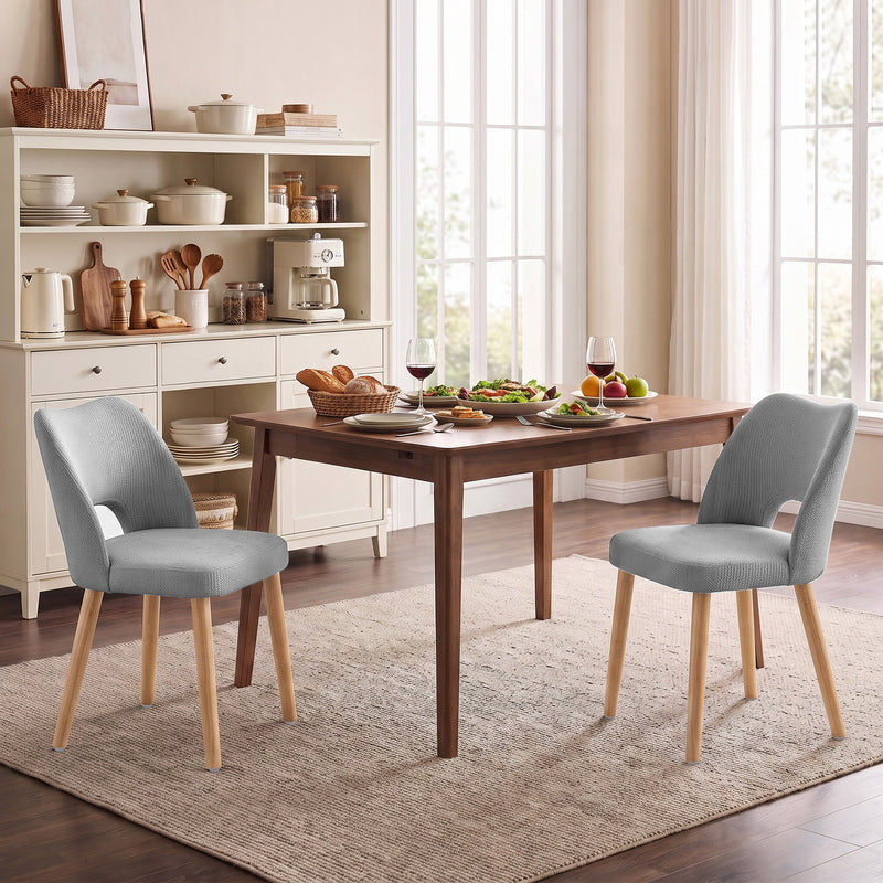 Two grey dining chairs at a table in a kitchen diner