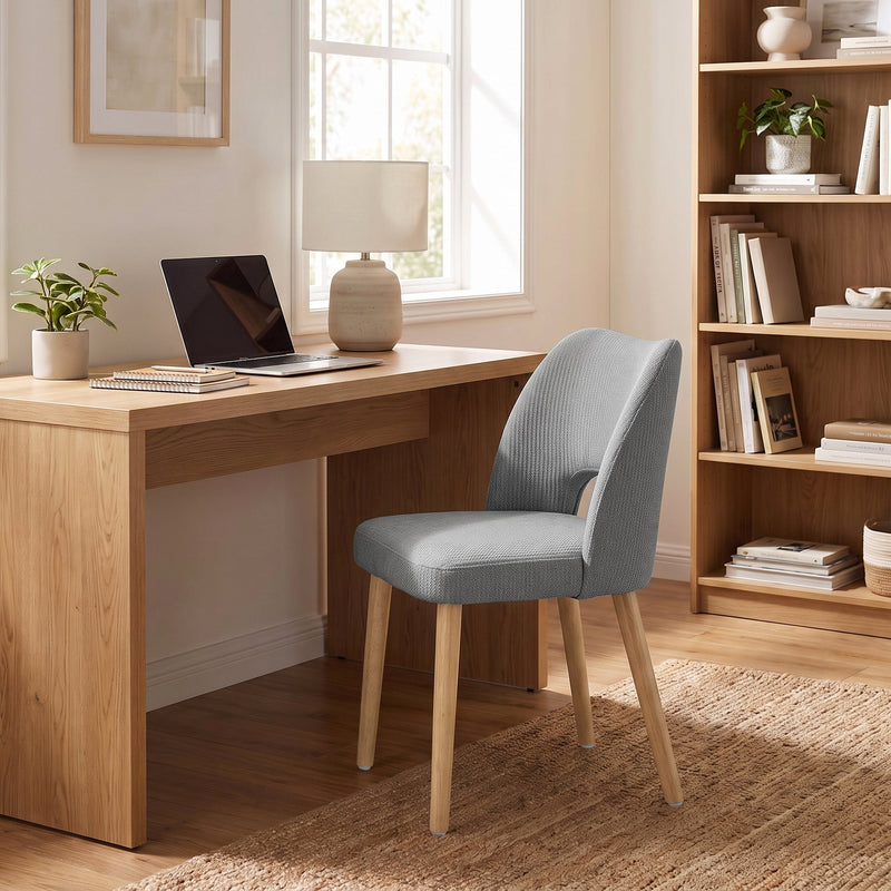 Grey dining chair used as a desk chair in a home office