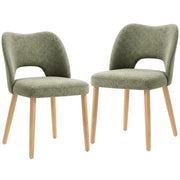 Two green chenille dining chairs with natural rubberwood legs on a white background