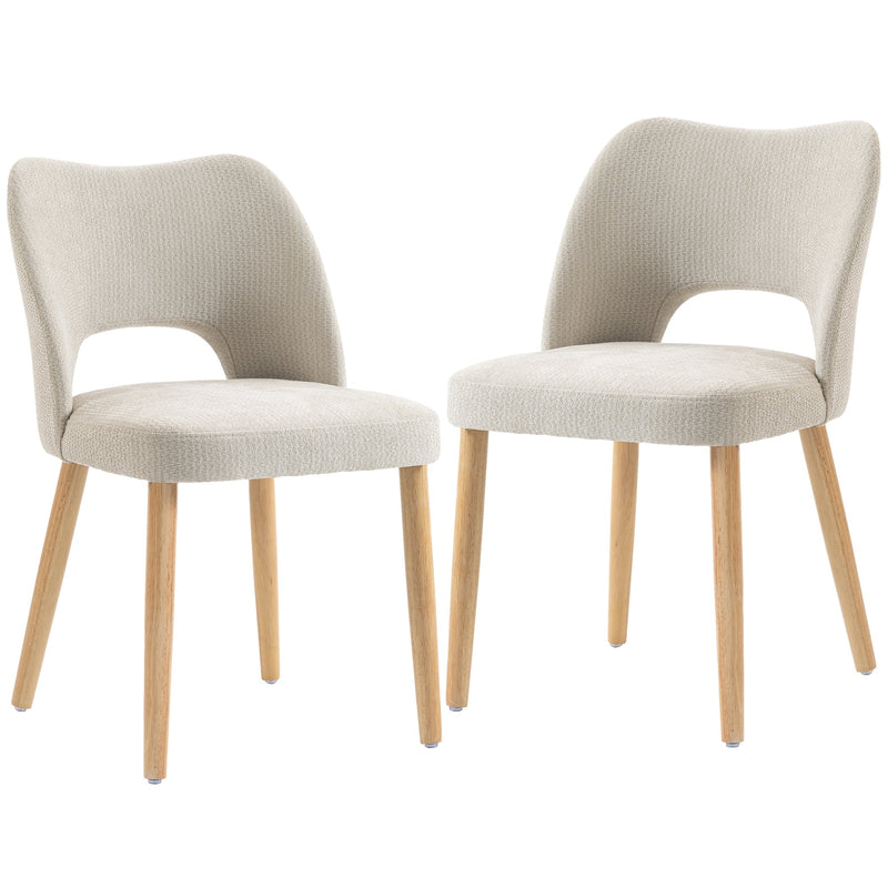 Two beige chenille dining chairs with natural rubberwood legs on a white background