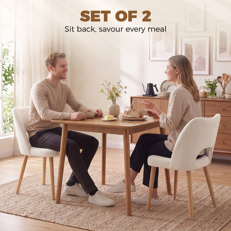Couple eating at a wooden dining table with beige chenille chairs