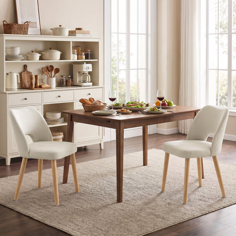 Two beige dining chairs at a table in a kitchen diner