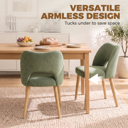 Armless green dining chairs tucked under a wooden table