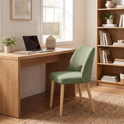Green dining chair used as a desk chair in a home office