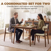 Couple eating at a dining table with two beige chenille chairs