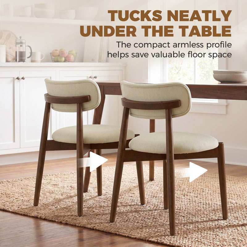 Two beige armless dining chairs tucked under a wooden table