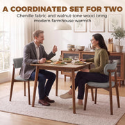 Couple eating at a dining table with two grey chenille chairs