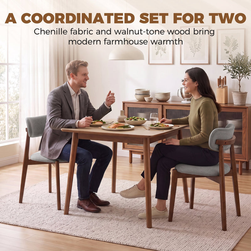 Couple eating at a dining table with two grey chenille chairs
