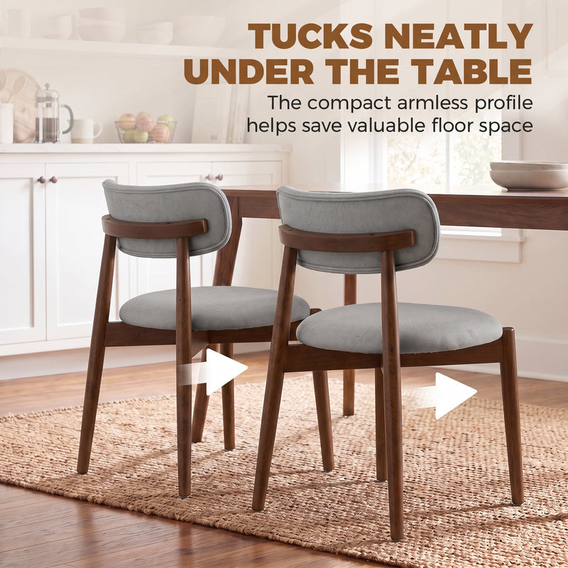 Two grey armless dining chairs tucked under a wooden table