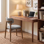 Grey dining chair used at a wooden home office desk