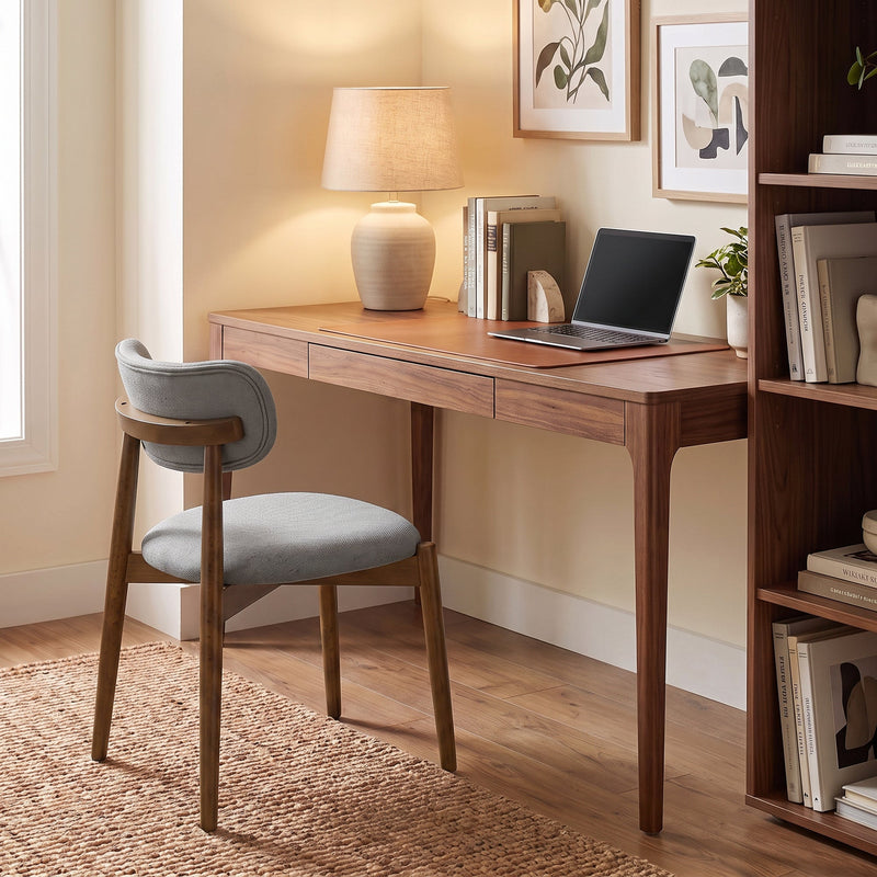 Grey dining chair used at a wooden home office desk