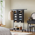 Two grey foldable hanging wardrobe organisers mounted on a clothes rail beside a dressing table, storing folded clothes, shoes and bags