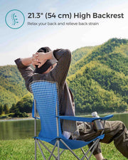 Man leaning back in the blue camping chair by a lake, with a note about the 54 cm high backrest