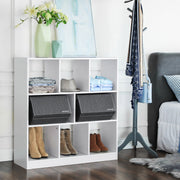 The two grey boxes side by side in a white shelving unit with clothes and boots