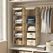 Two Sand Beige hanging organisers on a wardrobe rail next to hanging shirts and fabric baskets