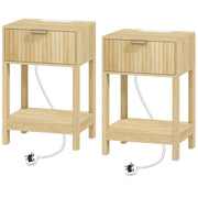Pair of oak fluted bedside tables with drawers and open shelves, power cables trailing from each