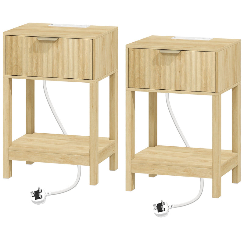 Pair of oak fluted bedside tables with drawers and open shelves, power cables trailing from each