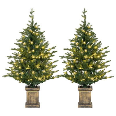 Pair of pre-lit 4ft Christmas trees in distressed bronze pots on a white background