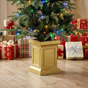 Close-up of an Aspen Fir tree with multicolour lights in a gold-tone pot beside gifts