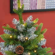 2ft set Christmas tree close-up of frosted tips, pinecone and warm white LEDs