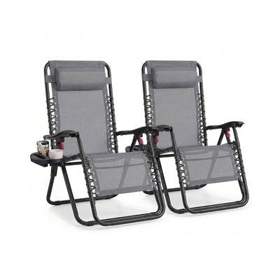 Pair of dark grey zero gravity chairs with mesh seats and sliding headrest pillows