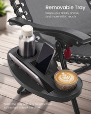 Close-up of the removable tray holding a bottle, a phone and a cup of coffee
