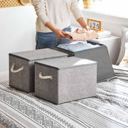 Storage boxes styled on a bedroom shelf holding clothes
