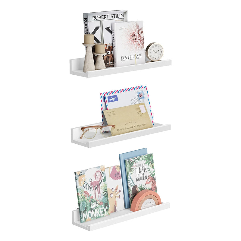 Three white Songmics ledge shelves holding books, photo frames and a clock