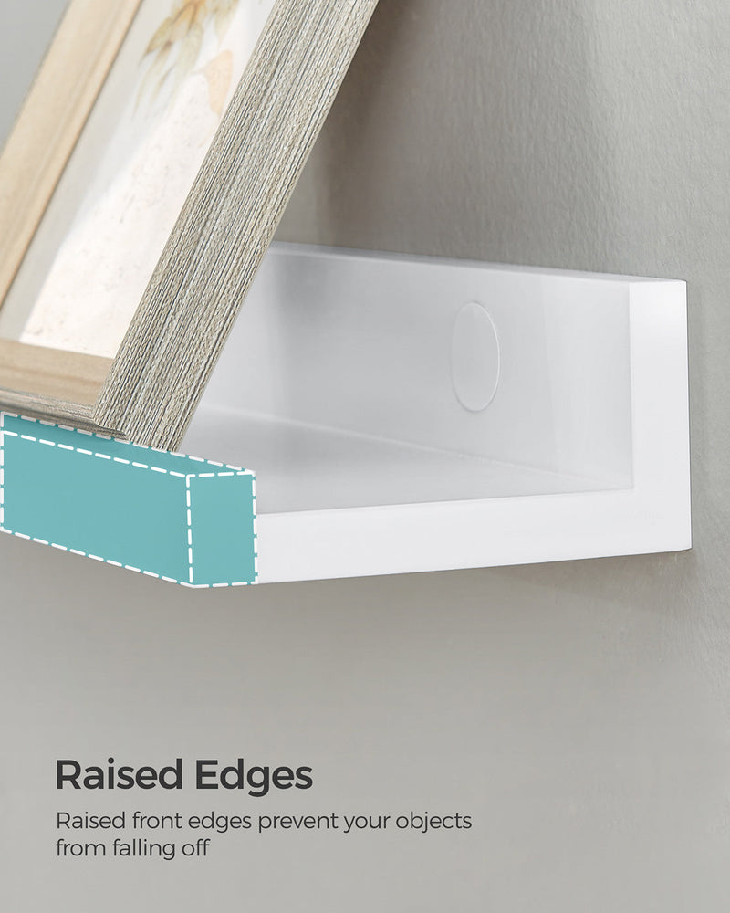 Close-up of a picture frame leaning on the raised front edge of the ledge shelf