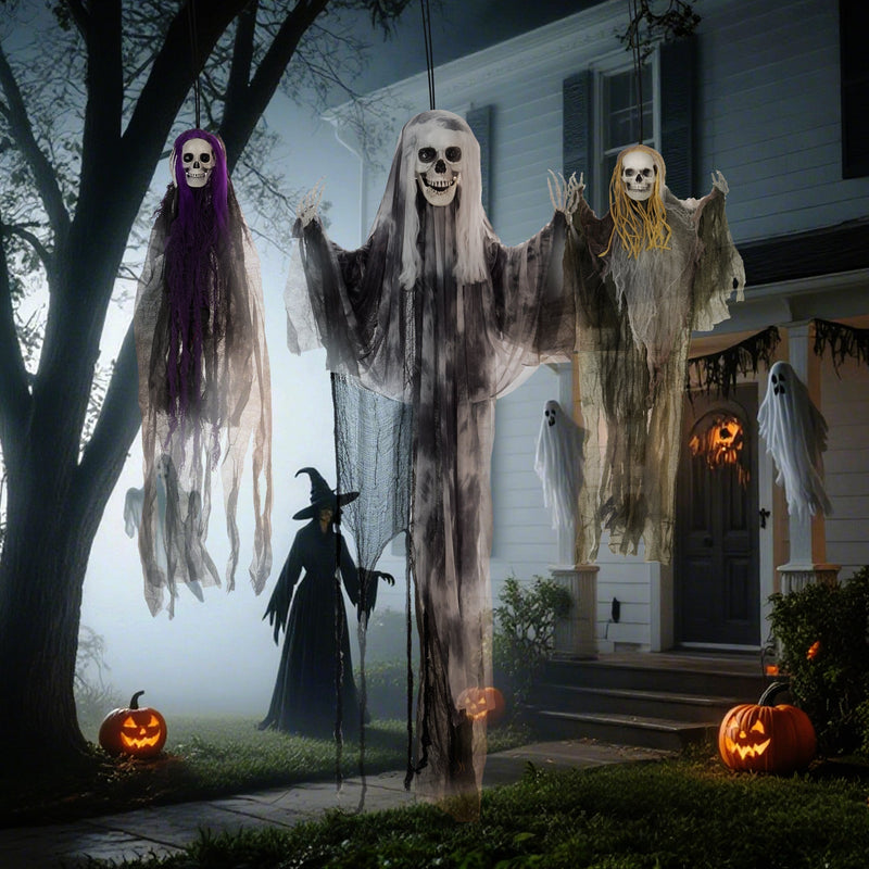 Three hanging skeleton decorations displayed near a tree in a misty garden at dusk