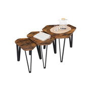 The three nesting tables styled with a glass teapot, tumblers and an open book