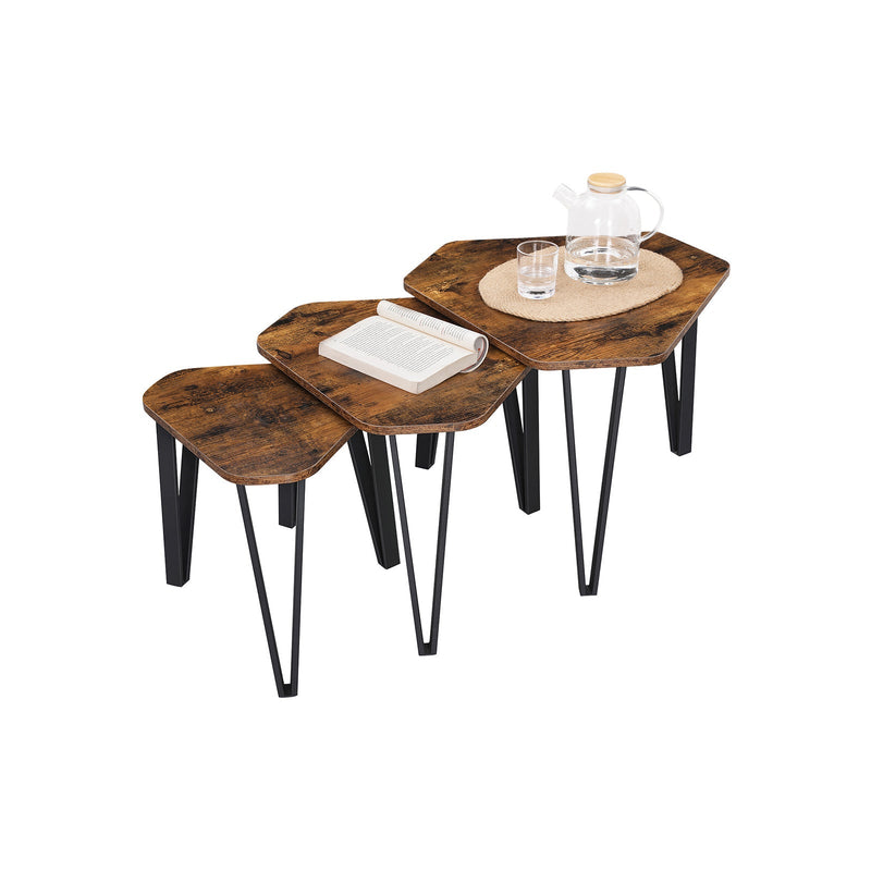 The three nesting tables styled with a glass teapot, tumblers and an open book