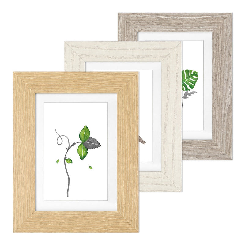 Three picture frames in light brown, white and grey wood grain finishes, each with a white photo mount