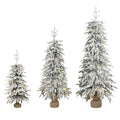 Set of 3 snow-flocked Christmas trees with fabric-wrapped bases on a white background