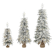 Set of 3 snow-flocked Christmas trees with fabric-wrapped bases on a white background