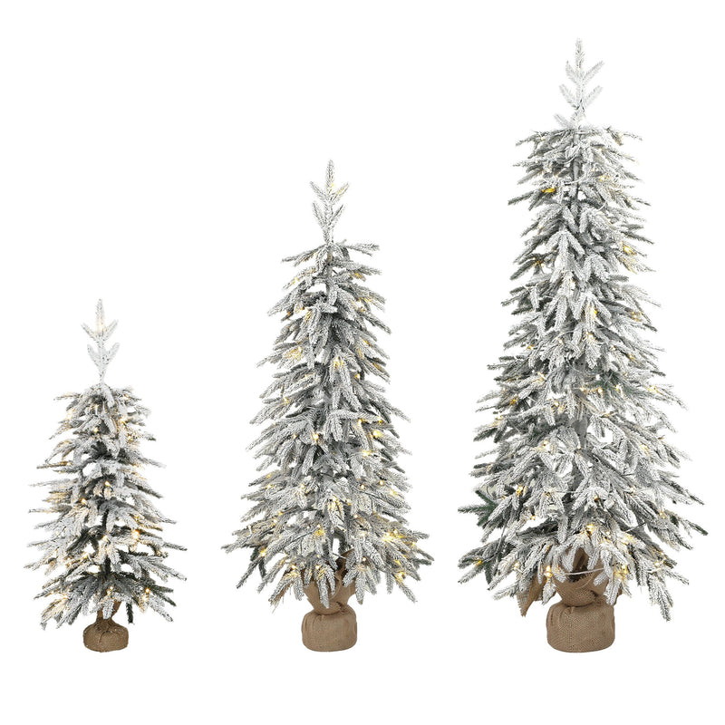 Set of 3 snow-flocked Christmas trees with fabric-wrapped bases on a white background