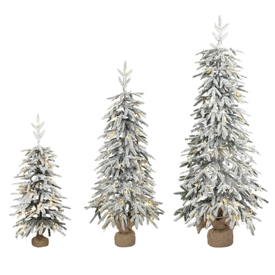 Set of 3 snow-flocked Christmas trees with fabric-wrapped bases on a white background
