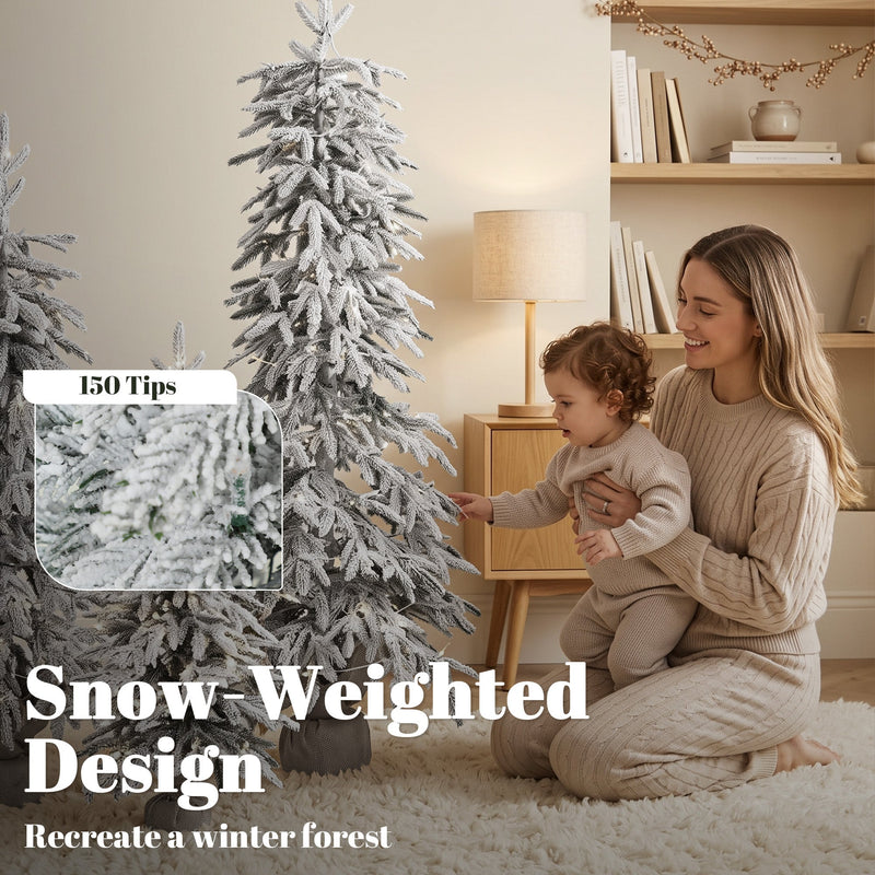 Mother and toddler beside a flocked tree with a 150 tips callout