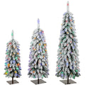 Set of 3 snow-flocked Christmas trees with multicolour lights on black metal stands