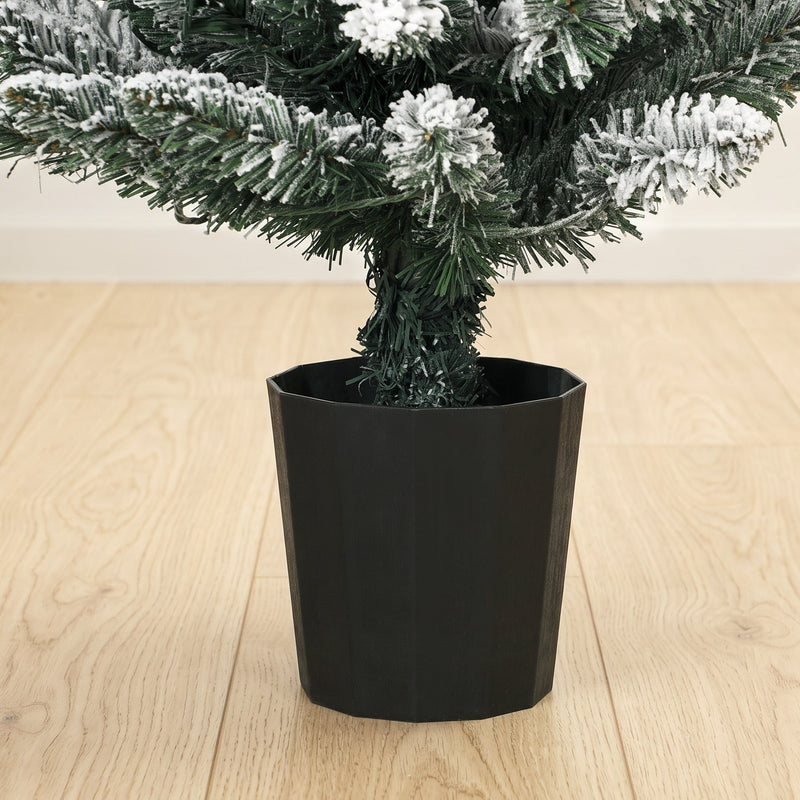 Close-up of the black plastic pot base and flocked branches
